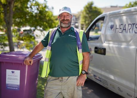 Man standing in front of bin