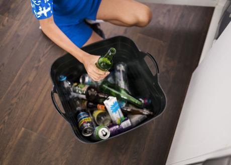 Person sorting containers in bucket