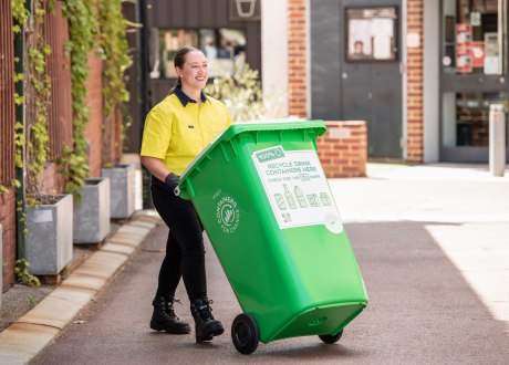 a women collecting a bin full of containers